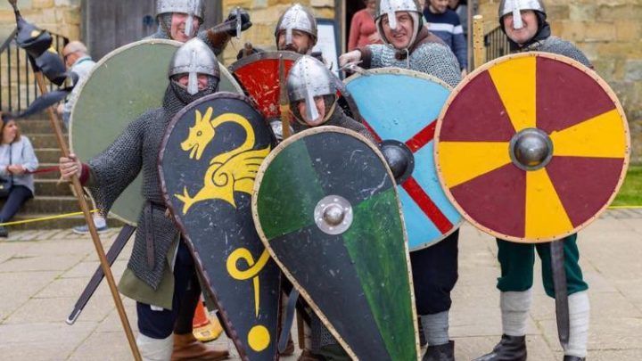 Historical re-enactors with shields near Battle Abbey in East Sussex