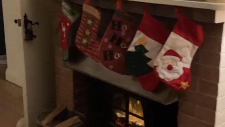 Fireplace decorated with Christmas stockings and festive decorations at Blackfirs Farmhouse