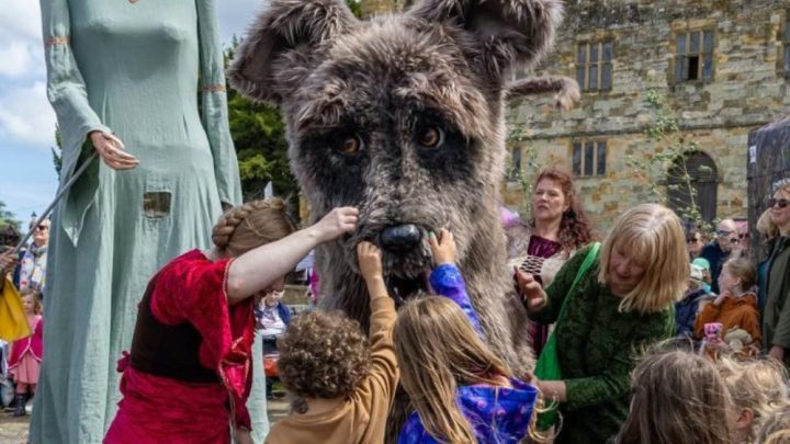 Children meeting costumed characters at a family event in Battle, East Sussex
