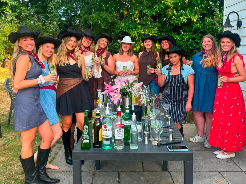 Group of friends enjoying a cocktail-making session at Blackfirs Farmhouse
