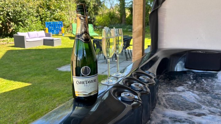 Private hot tub with sparkling wine overlooking the garden at Blackfirs Farmhouse