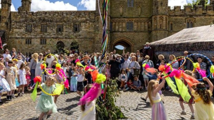 Children taking part in maypole dancing at a local event near Battle Abbey