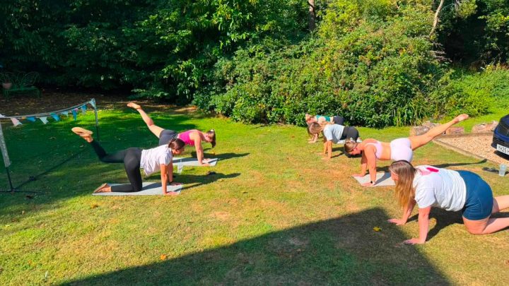 Group enjoying an outdoor wellness session in the garden at Blackfirs Farmhouse